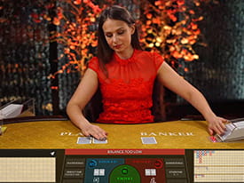 Baccarat live dealer er i færd med at give kort til både spiller og bank