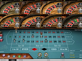 Et blåt roulettebord og otte forskellige roulettehjul, hvori kugler spinner rundt